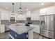 Bright kitchen features a granite island, stainless steel appliances, and white cabinets at 171 Piney Field Rd, Fuquay Varina, NC 27526