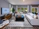 Comfortable living room with plush seating, a modern rug, and large windows at 1720 Pie Filling Dr, Haw River, NC 27258