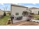A wooden deck has a dining set and grill, with steps leading to the yard at 1720 Waddell Ct, Durham, NC 27703