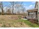 A tiered backyard with a screened-in porch and a privacy fence at 1720 Waddell Ct, Durham, NC 27703