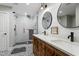 Beautifully renovated bathroom featuring double vanity, shiplap walls, stylish mirrors, and a glass-enclosed shower at 1720 Waddell Ct, Durham, NC 27703