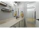 Well-lit bathroom featuring a spacious countertop, modern fixtures, and a shower with tiled walls at 1720 Waddell Ct, Durham, NC 27703
