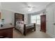 Comfortable bedroom featuring a custom wood headboard, large window, and ample natural light at 1720 Waddell Ct, Durham, NC 27703