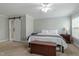 Bright bedroom featuring a sliding barn door, ceiling fan, and a charming decorative chest at the foot of the bed at 1720 Waddell Ct, Durham, NC 27703