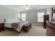 Serene bedroom featuring a comfortable bed, large windows, and classic wooden furniture at 1720 Waddell Ct, Durham, NC 27703