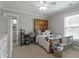 Bright bedroom with a unique wooden headboard, desk area, and ample storage at 1720 Waddell Ct, Durham, NC 27703