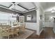 Dining room with wainscoting, a coffered ceiling, hardwood floors, and modern chandelier lighting at 1720 Waddell Ct, Durham, NC 27703