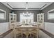 Elegant dining room featuring a round table, chandelier, and built-in cabinets at 1720 Waddell Ct, Durham, NC 27703