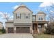 Charming two-story home with an attached three-car garage, stone accents, and a welcoming front porch at 1720 Waddell Ct, Durham, NC 27703