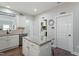 Kitchen island featuring granite countertop, and access to laundry and pantry at 1720 Waddell Ct, Durham, NC 27703