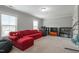 Spacious living room with a comfortable red sectional sofa and plenty of natural light at 1720 Waddell Ct, Durham, NC 27703