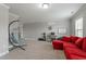 Comfortable living area featuring a stylish egg chair, red sectional sofa, and ample space for relaxing at 1720 Waddell Ct, Durham, NC 27703