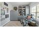 Cozy office with an upholstered chair, ottoman, built-in shelving, and natural lighting at 1720 Waddell Ct, Durham, NC 27703
