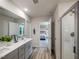 Well-lit bathroom with double vanity, modern fixtures, and a glass-enclosed shower with a walk-in closet at 1745 Pie Filling Dr, Haw River, NC 27258