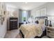 Cozy bedroom with a comfortable bed, a black dresser, and a window with blue curtains at 1745 Pie Filling Dr, Haw River, NC 27258