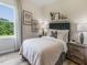 A cozy bedroom bathed in natural light, featuring chic decor, soft textures, and a tranquil ambiance at 1745 Pie Filling Dr, Haw River, NC 27258