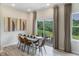 Bright dining room with a table, six chairs, and a sliding door leading to the backyard at 1745 Pie Filling Dr, Haw River, NC 27258