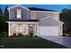 New two-story home with blue and gray siding, a well-manicured lawn, and an attached two-car garage at 1745 Pie Filling Dr, Haw River, NC 27258