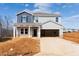 New two-story home with blue and gray siding and an attached two-car garage in a construction zone at 1745 Pie Filling Dr, Haw River, NC 27258