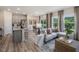 Open-concept living area with kitchen, dining area, and a comfortable gray sofa at 1745 Pie Filling Dr, Haw River, NC 27258