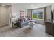 This cozy living room features a sectional sofa and views to the homes in the neighborhood at 1745 Pie Filling Dr, Haw River, NC 27258