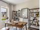 Study featuring a wooden desk, bookshelves, and a window with natural light at 1745 Pie Filling Dr, Haw River, NC 27258