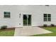 Backyard patio featuring a sliding glass door, well-maintained grass and landscape bush at 186 Ethel Ln, Angier, NC 27501