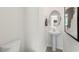 Half bathroom with pedestal sink, oval mirror, and white walls at 186 Ethel Ln, Angier, NC 27501