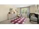 Cozy bedroom features a crib, large rug and a window with curtains at 186 Ethel Ln, Angier, NC 27501
