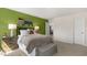 Comfortable bedroom with a green accent wall, modern lamps, and a decorative scoreboard sign above the headboard at 186 Ethel Ln, Angier, NC 27501