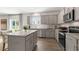 Modern kitchen boasts stainless steel appliances, gray cabinets, granite countertops and wood-look flooring at 186 Ethel Ln, Angier, NC 27501