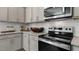 Close up of kitchen featuring stainless steel oven, microwave, subway tile backsplash and granite countertops at 186 Ethel Ln, Angier, NC 27501