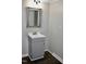 Bathroom featuring a silver framed mirror over a gray vanity with wood-look flooring at 1960 Brogden Rd, Smithfield, NC 27577
