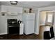 Efficient kitchen with an electric range, classic white cabinets, and modern flooring at 1960 Brogden Rd, Smithfield, NC 27577