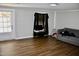 Living room featuring sleek, modern floors, light gray walls, a sofa, and a TV setup at 1960 Brogden Rd, Smithfield, NC 27577