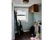 Utility room with window, cabinets, washer/dryer hookups and wood-look flooring at 1960 Brogden Rd, Smithfield, NC 27577