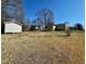 View of the house with a shed and grass backyard at 2001 S Ashland Dr, Burlington, NC 27217