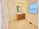 Bathroom with a vanity sink, tiled floor, and a large mirror at 2001 S Ashland Dr, Burlington, NC 27217