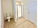 Bright bathroom featuring a glass shower, toilet, and neutral tile flooring at 2001 S Ashland Dr, Burlington, NC 27217