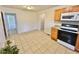 Open kitchen and dining area offers tile floors and a microwave over the range at 2001 S Ashland Dr, Burlington, NC 27217