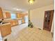 Kitchen with wood cabinets, tile flooring, and a view to the backyard at 2001 S Ashland Dr, Burlington, NC 27217