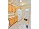 Kitchen with wood cabinets, stainless steel refrigerator, and tile flooring at 2001 S Ashland Dr, Burlington, NC 27217