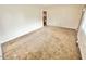 Bright living room featuring neutral walls and carpet with a glimpse into the next room at 2001 S Ashland Dr, Burlington, NC 27217