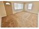 Open-concept living room with a carpeted floor, neutral walls, and a bright front door at 2001 S Ashland Dr, Burlington, NC 27217