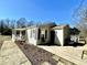Tan house with brown shutters, covered porch and a wooden deck with wire railing at 2001 S Ashland Dr, Burlington, NC 27217