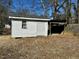 White shed with a door and a window in the backyard at 2001 S Ashland Dr, Burlington, NC 27217