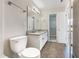 Bathroom featuring a dual sink vanity with granite countertop, walk-in closet, and toilet at 203 Canyon Lake Cir, Morrisville, NC 27560