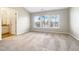 A bright bedroom with a neutral palette, vaulted ceilings, and three large windows at 203 Canyon Lake Cir, Morrisville, NC 27560