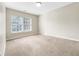 A bright bedroom with carpeted floors and a window offers a cozy and inviting space at 203 Canyon Lake Cir, Morrisville, NC 27560