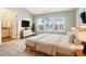 Bright bedroom featuring a neutral palette, vaulted ceilings, large windows, and ensuite bathroom access at 203 Canyon Lake Cir, Morrisville, NC 27560
